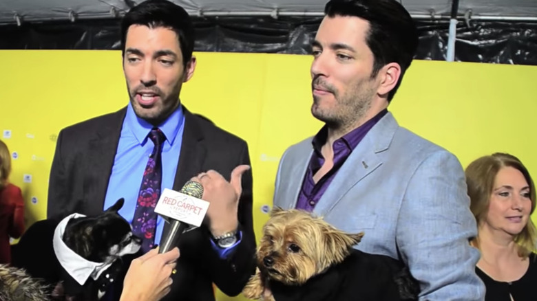 Property Brothers Jonathan Scott and Drew Scott with Jonathan's dogs