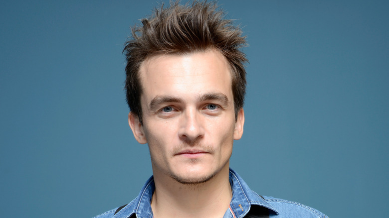 Rupert Friend blue background 