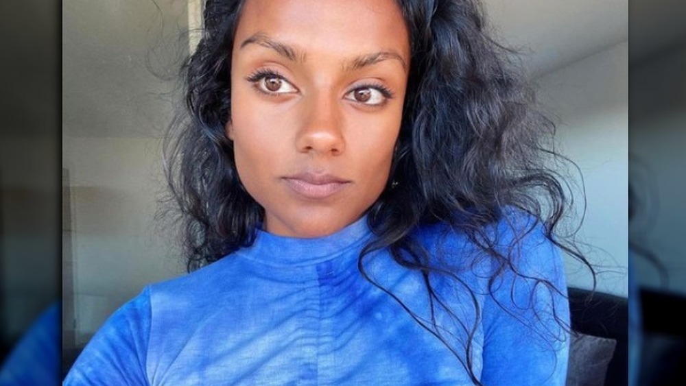 Simone Ashley wearing a bold blue shirt