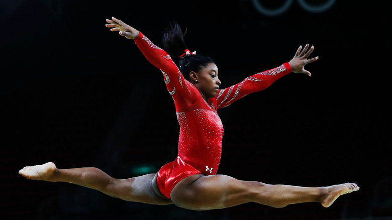 Simone Biles leaping through the air