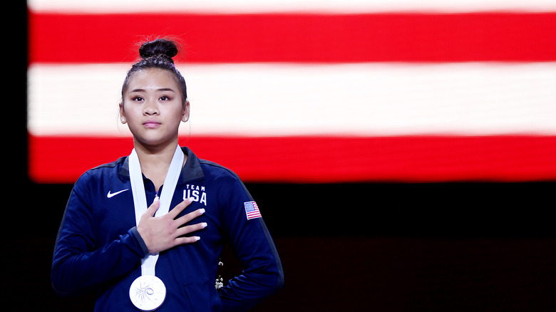 Sunisa Lee with her hand over her heart