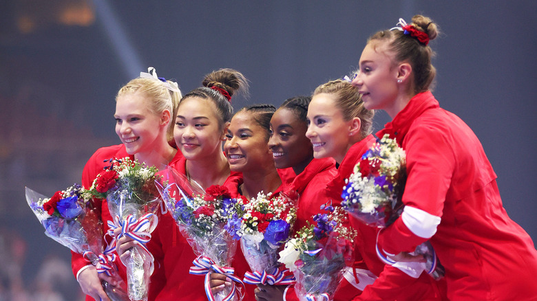 Sunisa Lee with her team mates with flowers