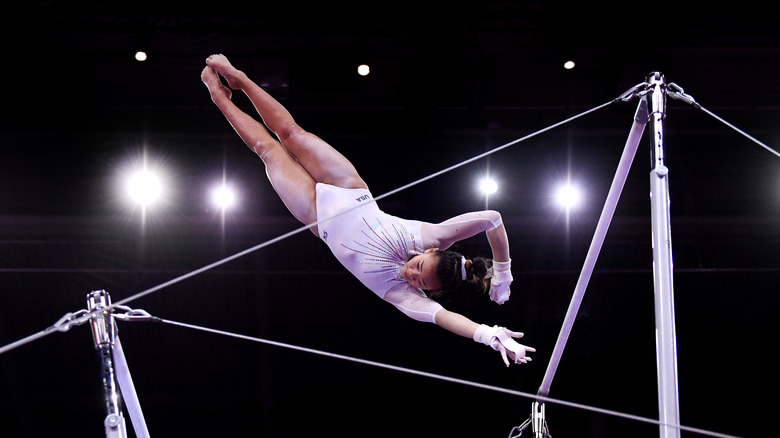 Sunisa Lee on uneven bars wearing white