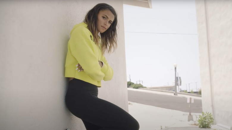 Sydney McLaughlin posing by a wall