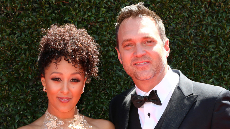 Tamera Mowry-Housley poses with husband Adam Housley