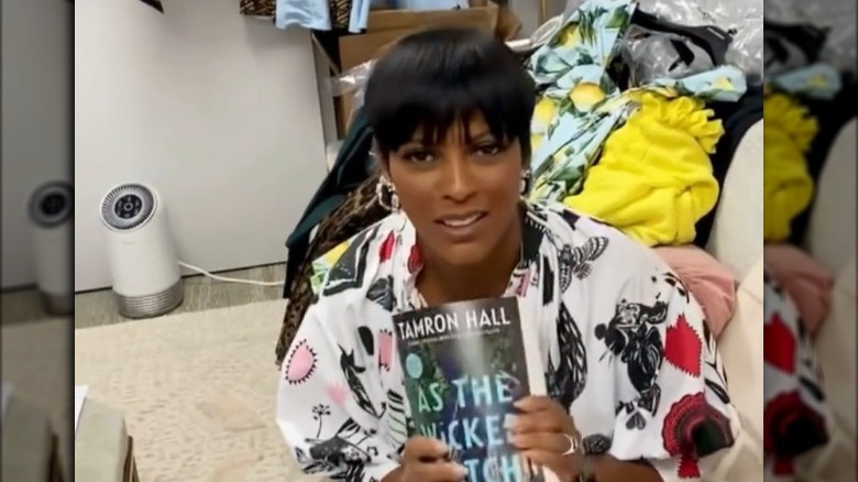 Tamron Hall showing off her book