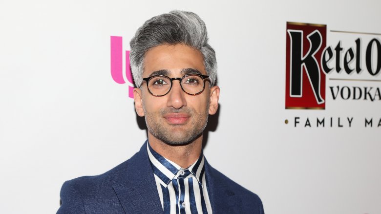 Queer Eye star Tan France wearing a suit and glasses