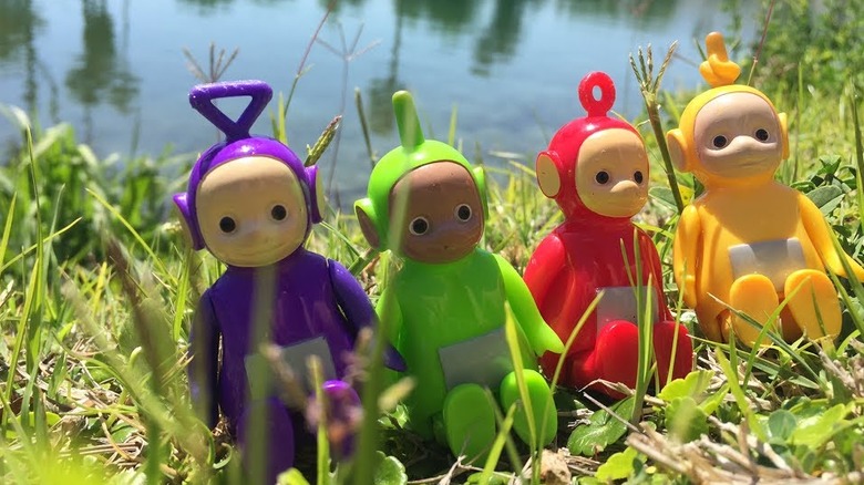 Teletubbies in front of pond