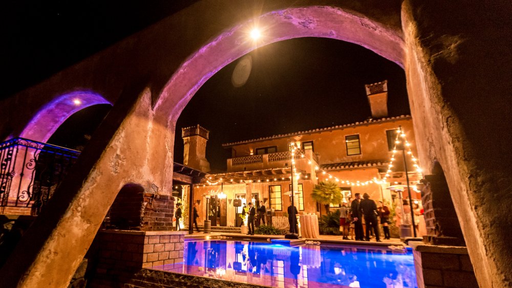 The Bachelor mansion, exterior view of the pool with pink lighting