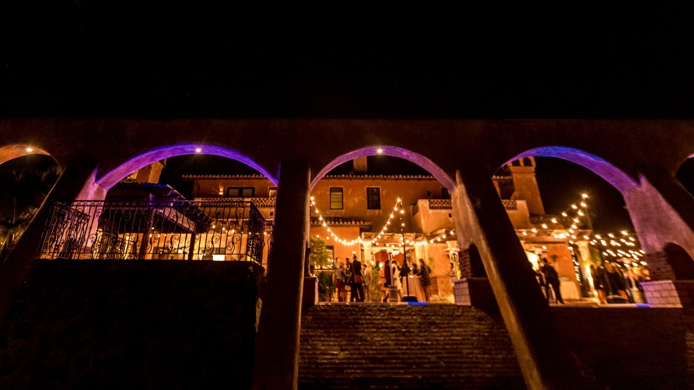 The exterior of The Bachelor mansion, lit up in th eevening