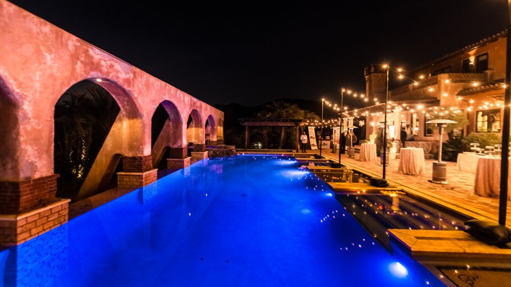 The exterior of The Bachelor mansion, pool and arches