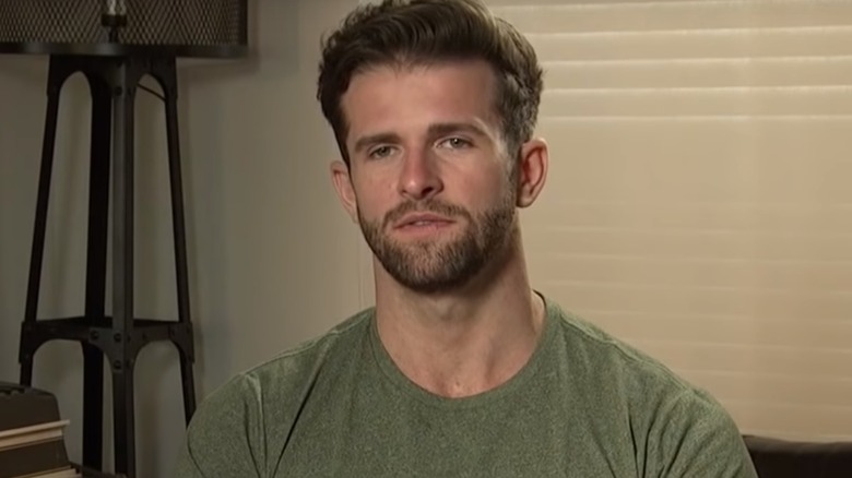 Jed Wyatt in a green shirt talking on The Bachelorette