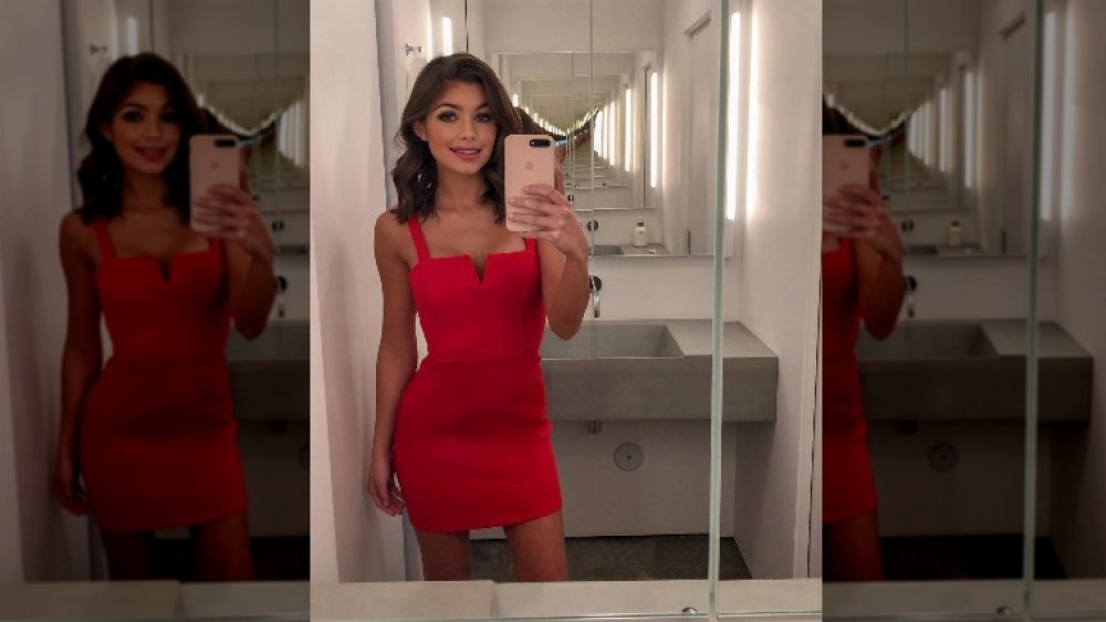 The Bachelor's Hannah Ann Sluss taking a selfie in a red dress