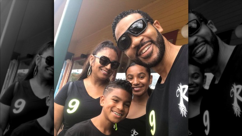 Aaron D. Spears, wife Estella, and two kids smiling