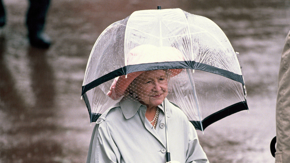 Queen Mother walking in the rain