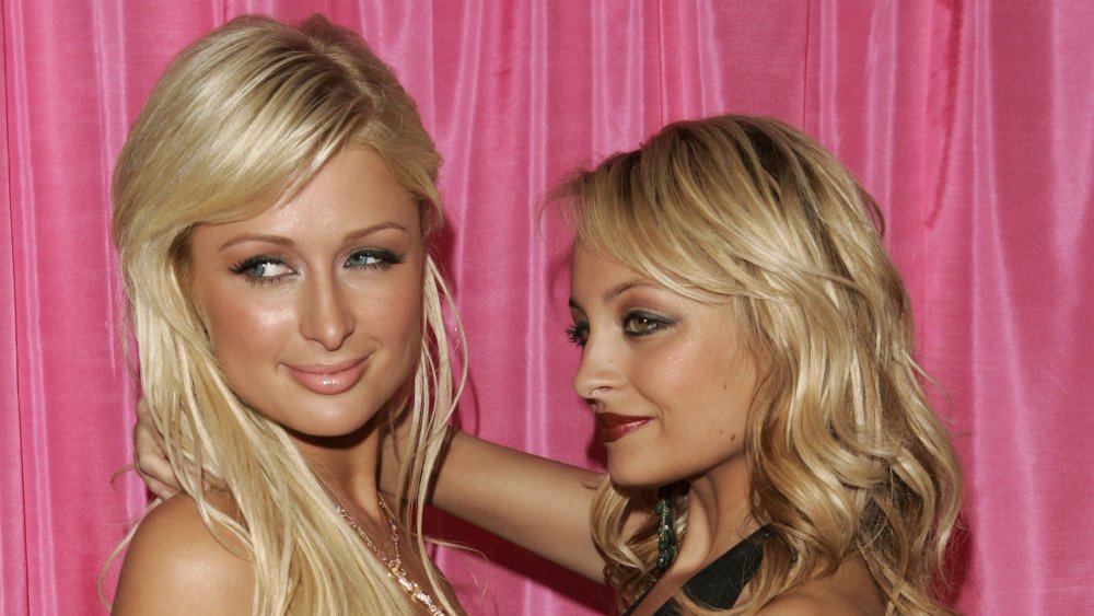 Paris Hilton and Nicole Richie from The Simple Life in front of a pick background