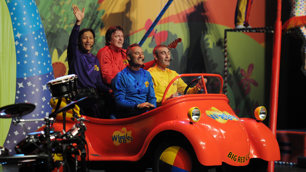 The Wiggles riding in a car onstage