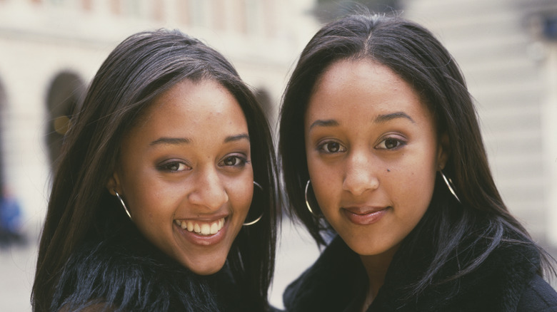 Young Tia Mowry posing with her twin sister