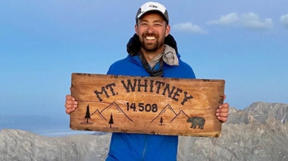 Spencer Shemwell smiling on a mountain