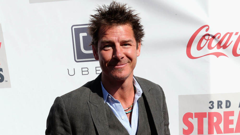 Ty Pennington wearing a suit, smiling