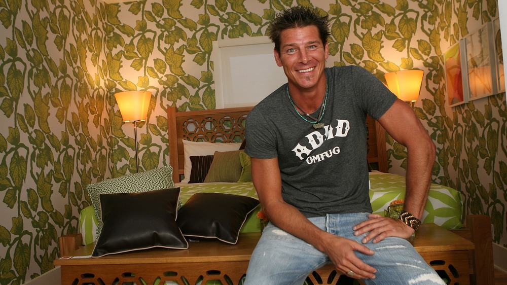 Ty Pennington sitting in a bedroom