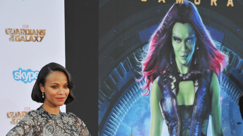 Zoe Saldana posing next to a Gamora image