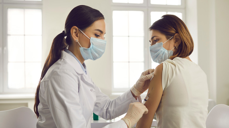 Image of woman receiving COVID vaccine