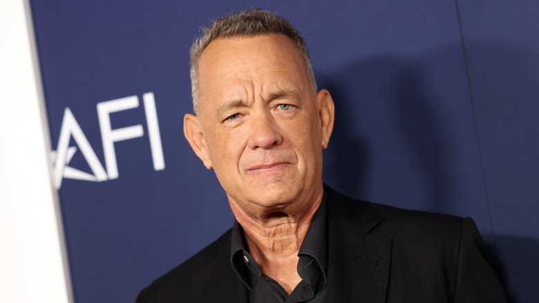 Tom Hanks looks at the camera