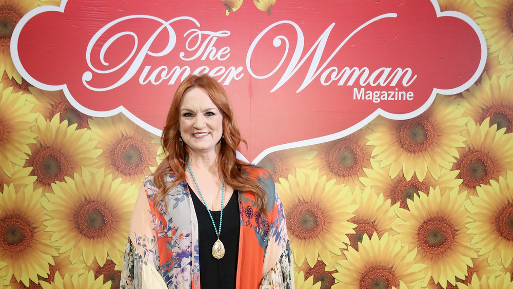 Ree Drummond smiling at event, flowers in background