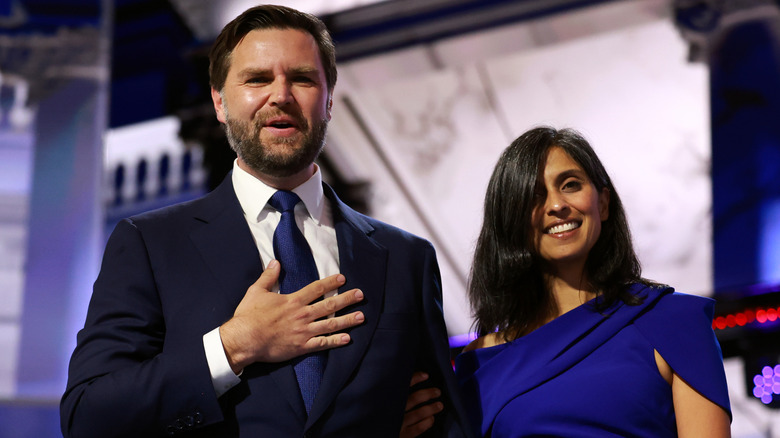 JD Vance with his hand over his heart and his wife ﻿his wife Usha Chilukuri Vance on stage on the third day of the Republican National Convention