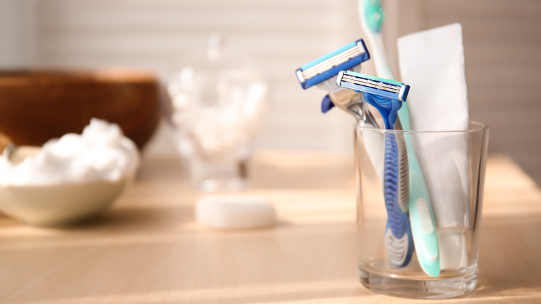 Disposable razors stored in a cup