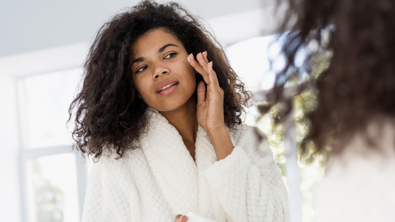 woman applying moisturizer