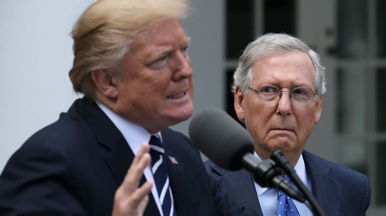 Mitch McConnell looks at Donald Trump