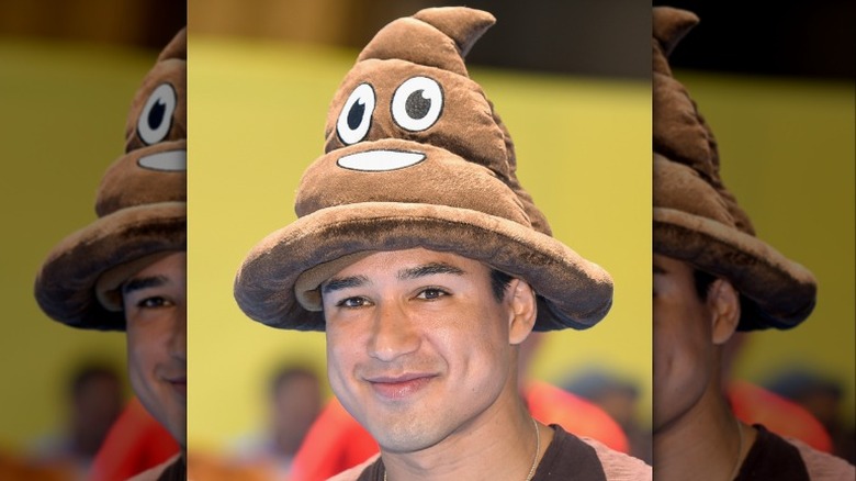 Mario Lopez in poop emoji hat