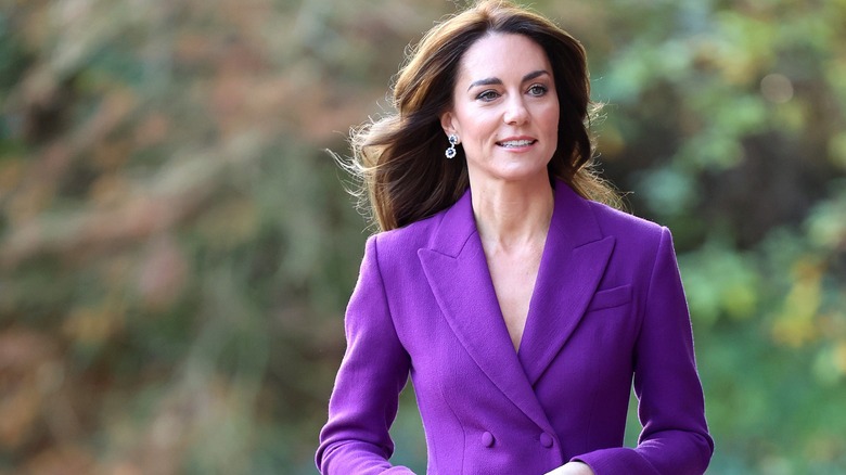 Kate Middleton walking in a purple suit