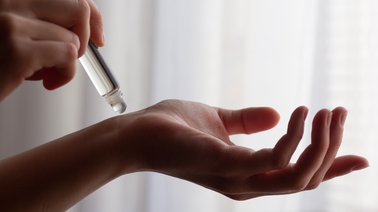 Woman applying perfume