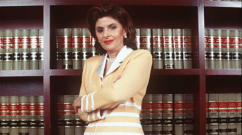 Gloria Allred standing in front of bookcase