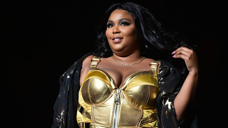 Lizzo smiling posing onstage