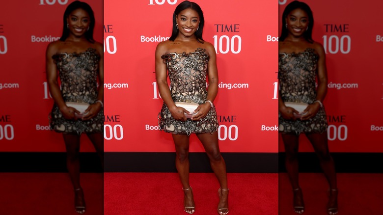 Simone Biles in short, strapless dress with squiggle pattern over a nude base