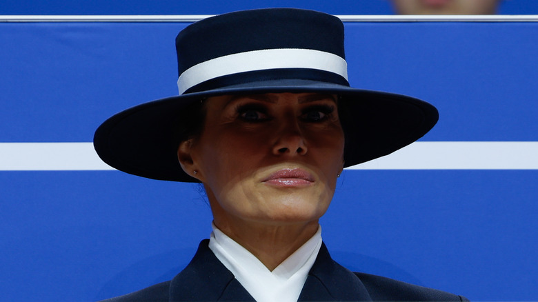 Melania Trump scowling in a hat