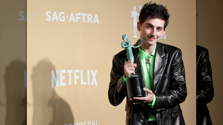 Timothee Chalamet smiling with SAG Award