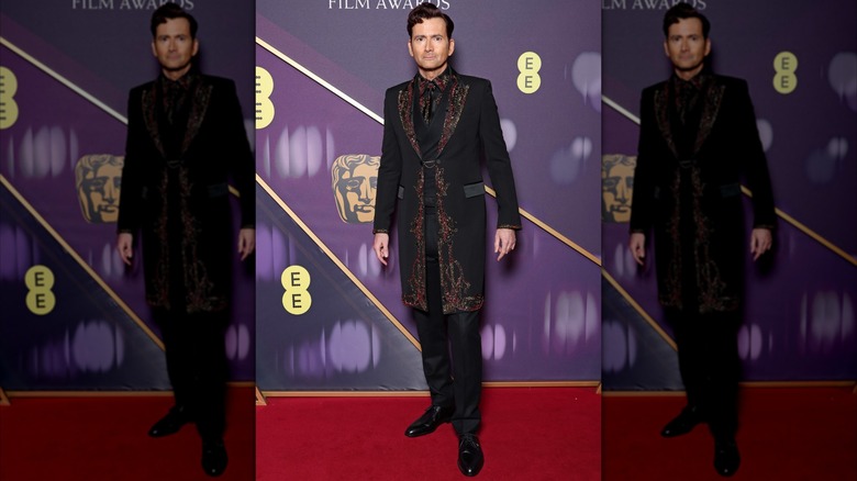 David Tennant posing in an embroidered coat at the BAFTA Awards