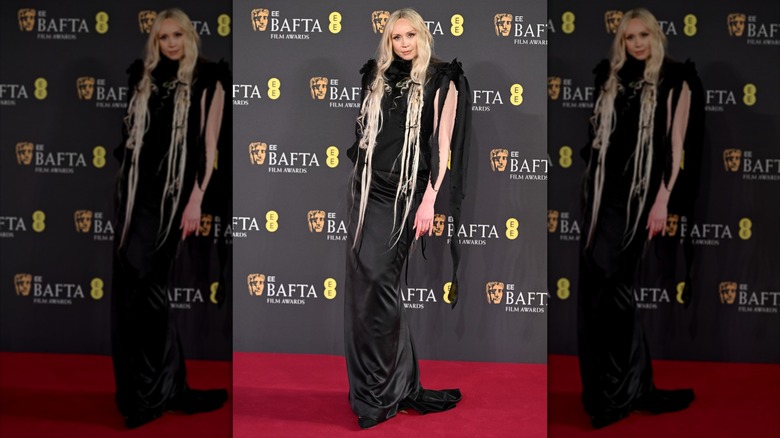 Gwendoline Christie posing in a black dress at the 2025 BAFTA Awards