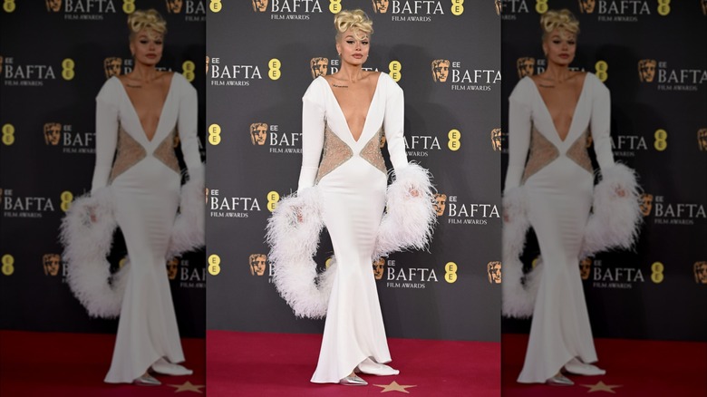 Pegah Pourmand wearing a white gown on the red carpet at the 2025 BAFTA Awards