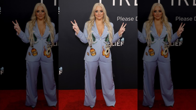 Jessie Jo Dillon posing in blue suit with embroidery