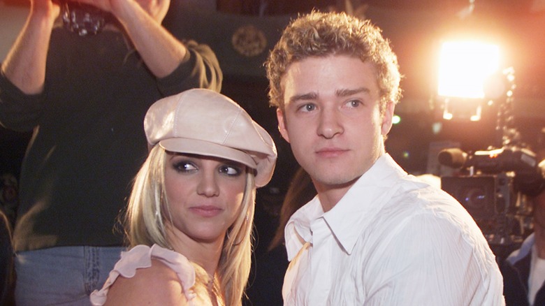 Britney Spears and Justin Timberlake looking over their shoulders