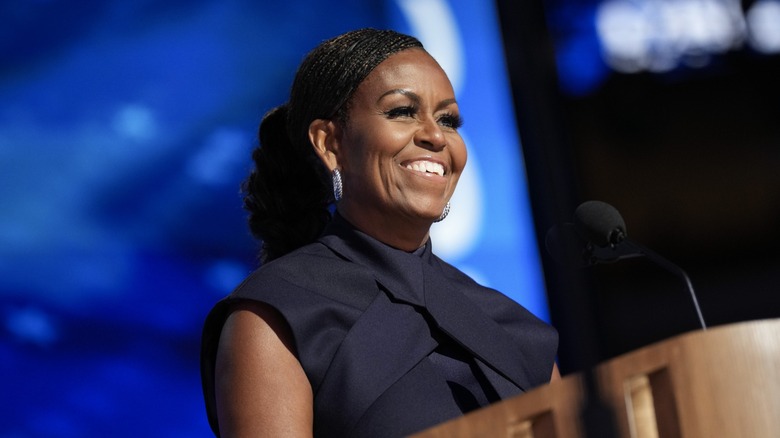 Michelle Obama smiling at podium