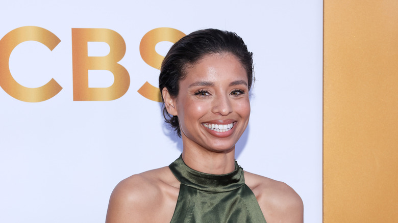 Brytni Sarpy smiling in front of a CBS banner