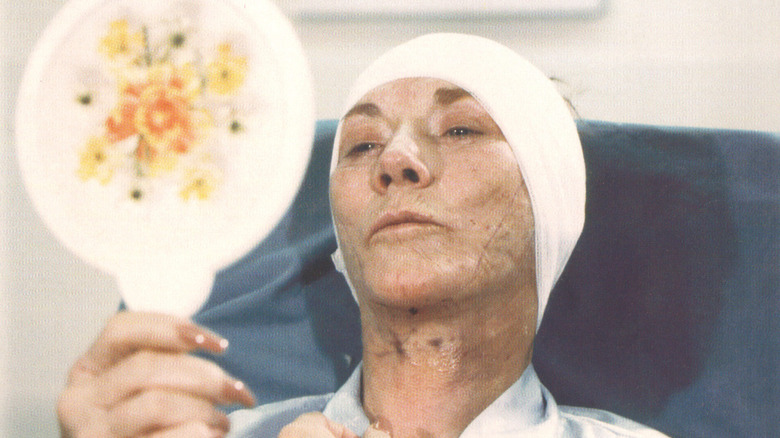 Jeanne Cooper/Kay Chancellor looking into a mirror for the first time after surgery