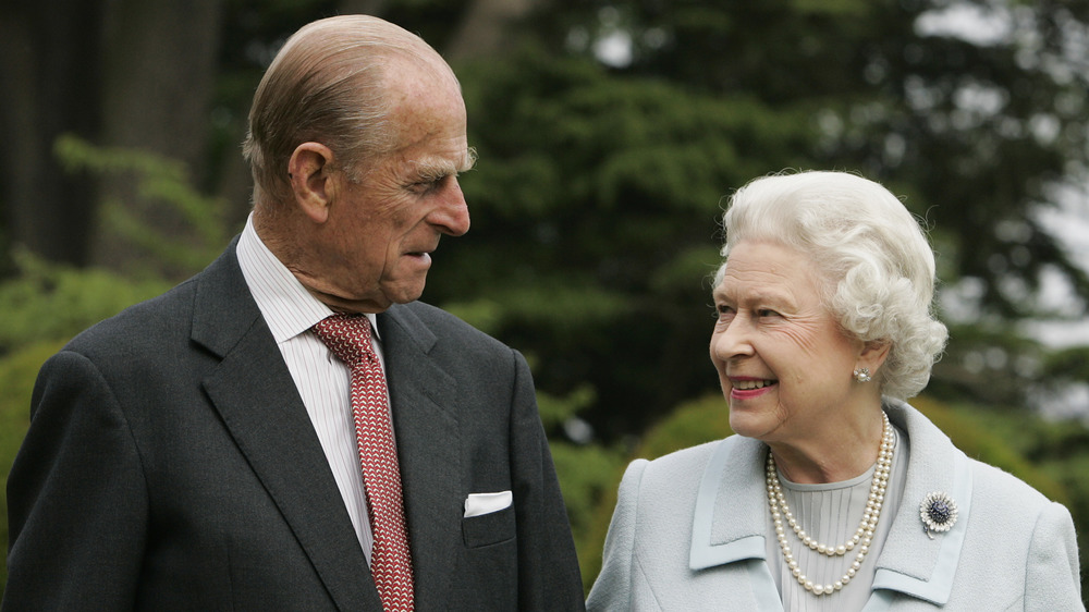 Prince Philip and Queen Elizabeth walking outside